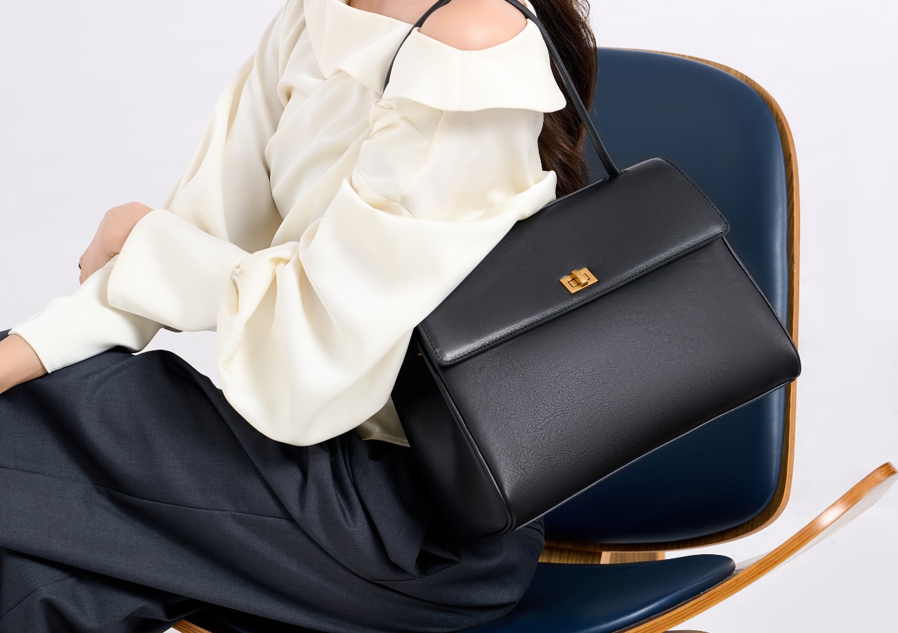 The tote bag offers ample space for daily essentials, books, and a laptop, combining style with practicality for versatile use.