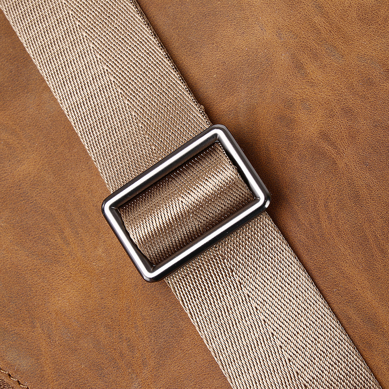 This image presents a close-up of a metallic rectangular buckle on a beige woven strap, set against a brown leather surface, highlighting the combination of durability and stylish design.