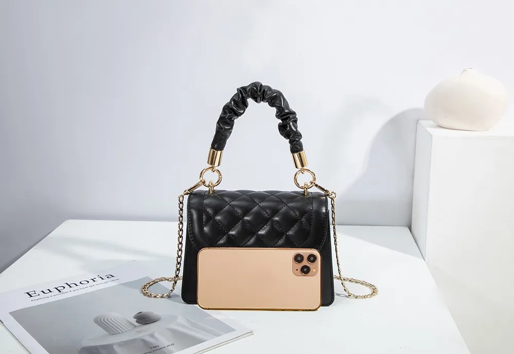 This BALIYA quilted tote is compact enough to hold a phone, featuring pleated handles and shiny gold-tone hardware.