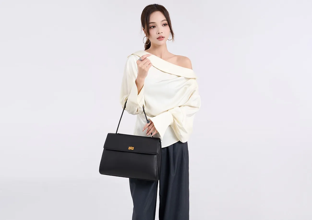 The tote bag offers ample space for daily essentials, books, and a laptop, combining style with practicality for versatile use.