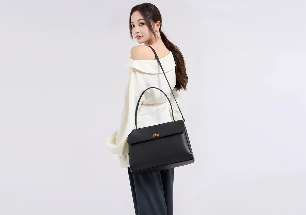 The tote bag offers ample space for daily essentials, books, and a laptop, combining style with practicality for versatile use.