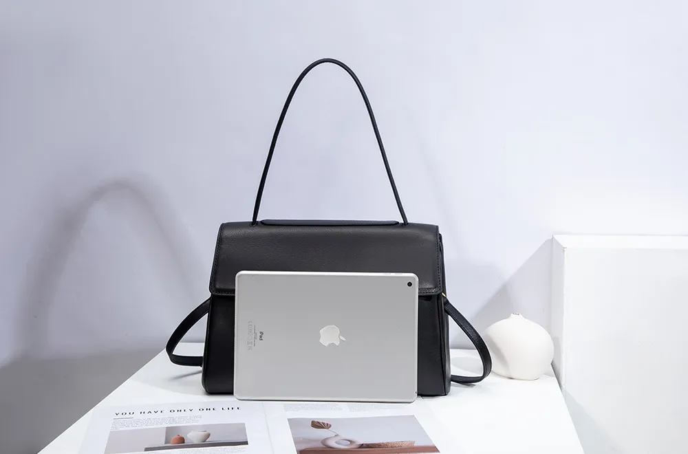 The red tote bag offers ample space for daily essentials, books, and a laptop, combining style with practicality for versatile use