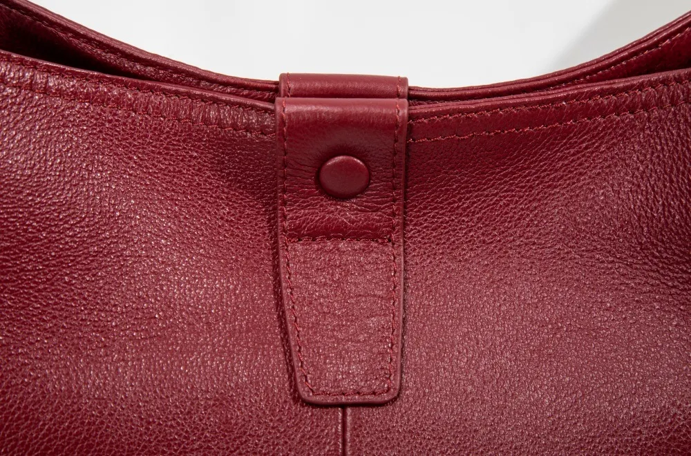 Genuine leather women's shoulder bag with sleek metal clasp—secure, chic, elevating the timeless design.