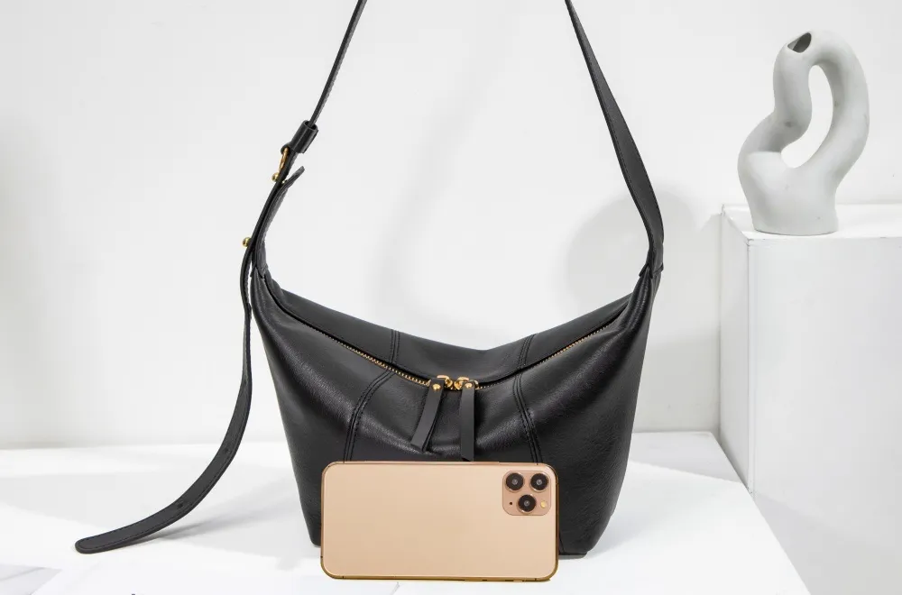 Crafted from buttery-soft genuine leather, this women's shoulder bag exudes understated luxury.