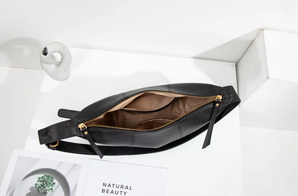 Black women's shoulder bag—small in size, big on capacity. Stylish, compact, holds plenty effortlessly.