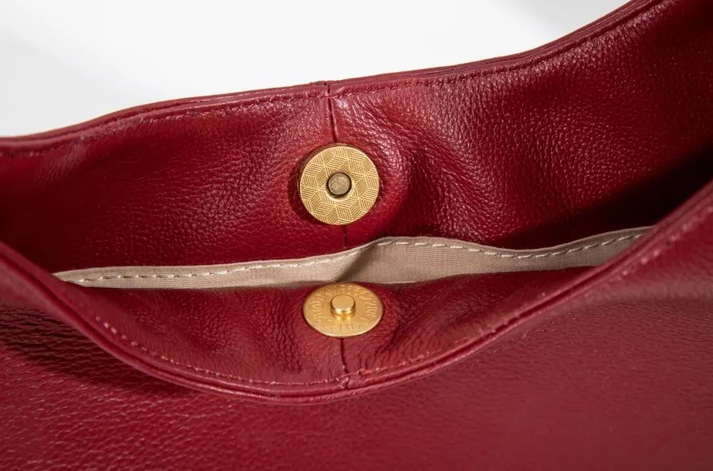 Genuine leather women's tote with polished hardware clasp—secure, sleek, enhancing its timeless allure.