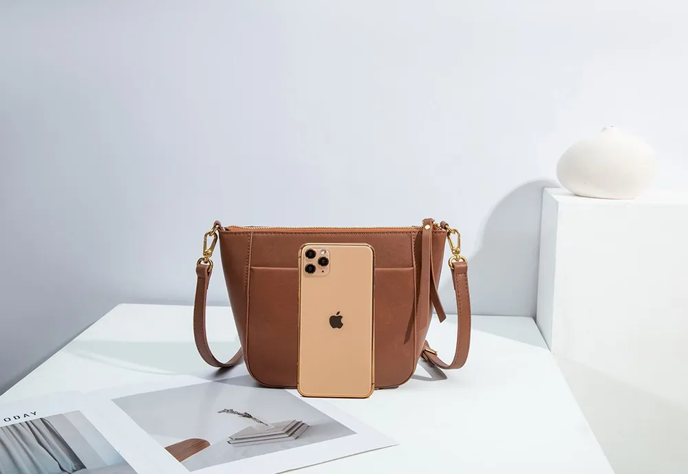 Crafted from premium Italian leather, this compact BALIYA crossbody bag features sleek lines, a convenient front pocket, and an organized interior. The compact silhouette meets exquisite craftsmanship for enduring quality.