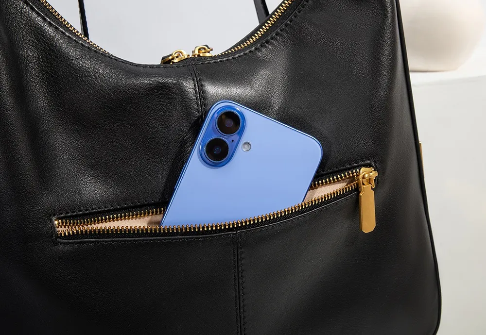 The bag's rear zippered pocket is crafted from high-quality top-grain cowhide and features the brand's signature smooth gold zipper.