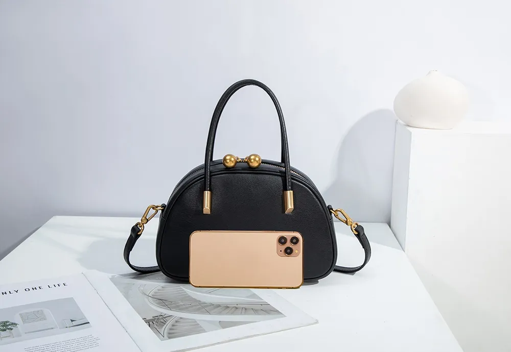 The black shell bag is an exquisite example of 'small in the palm of your hand'.